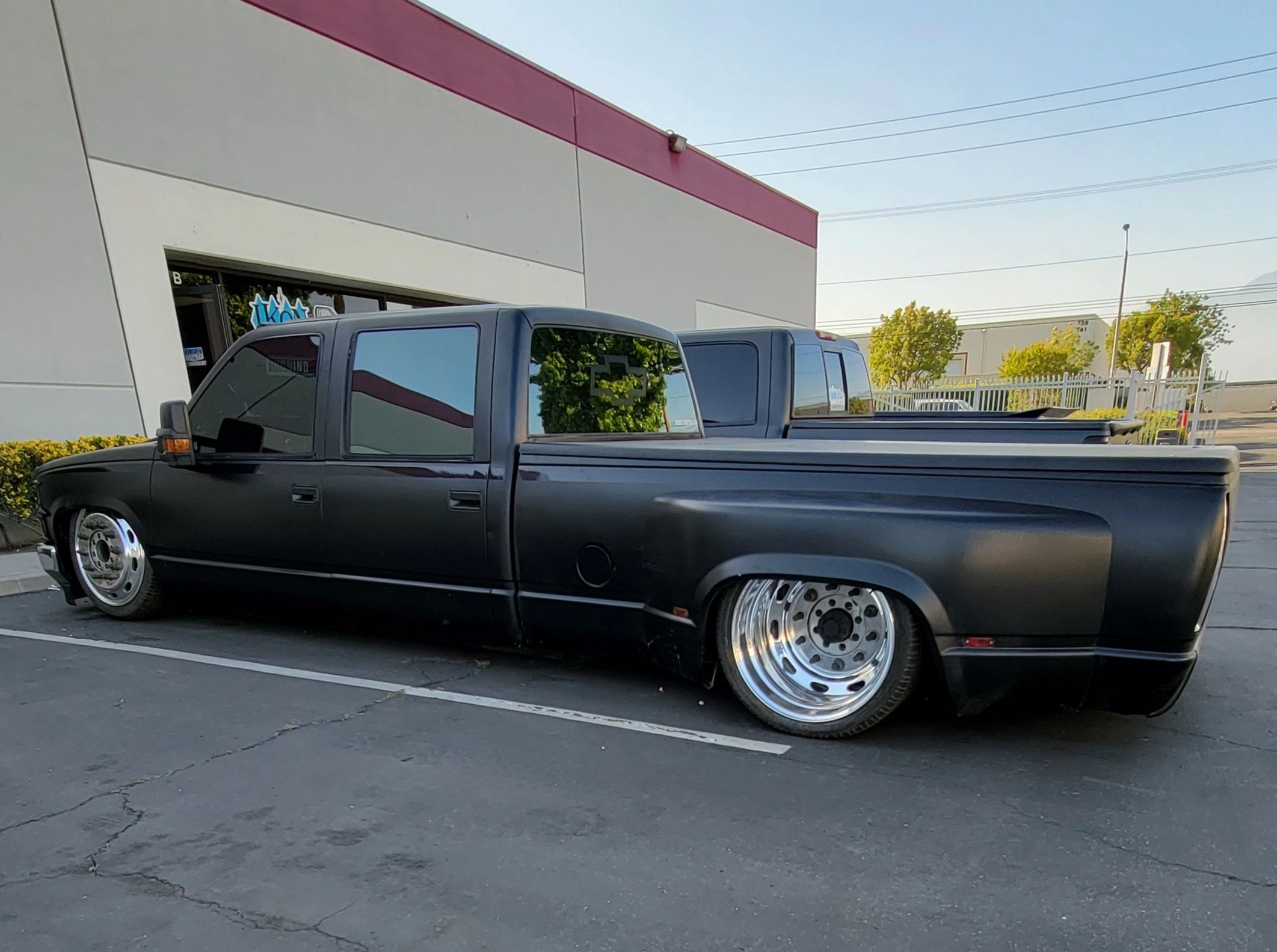 Bagged black dually truck air suspension by Ikon Industries